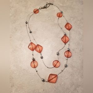 Beautiful layered necklace with coral and silver beads on a silver chain.